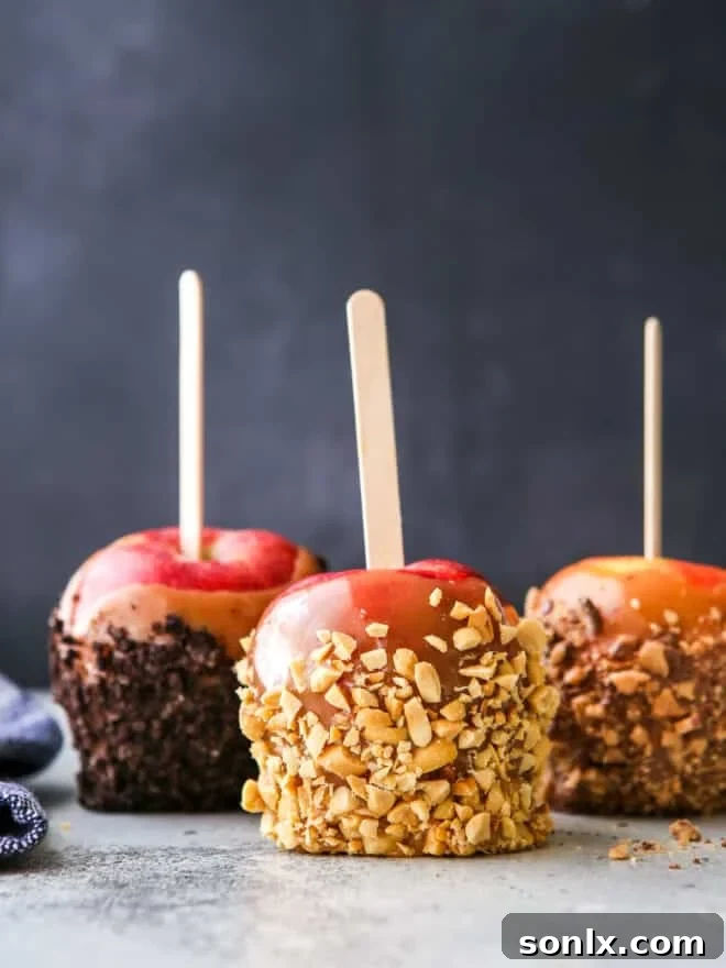 Close-up of three perfectly crafted homemade caramel apples, glistening with rich caramel and ready for a bite.