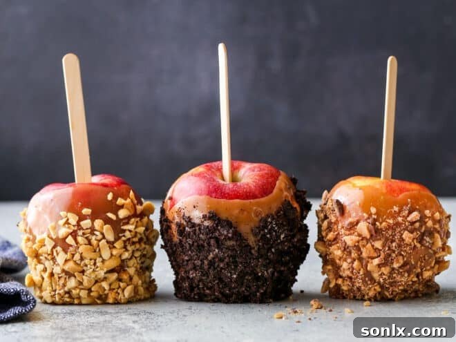 A neat row of various homemade caramel apples, some plain and some decorated with crunchy toppings, ready to set.
