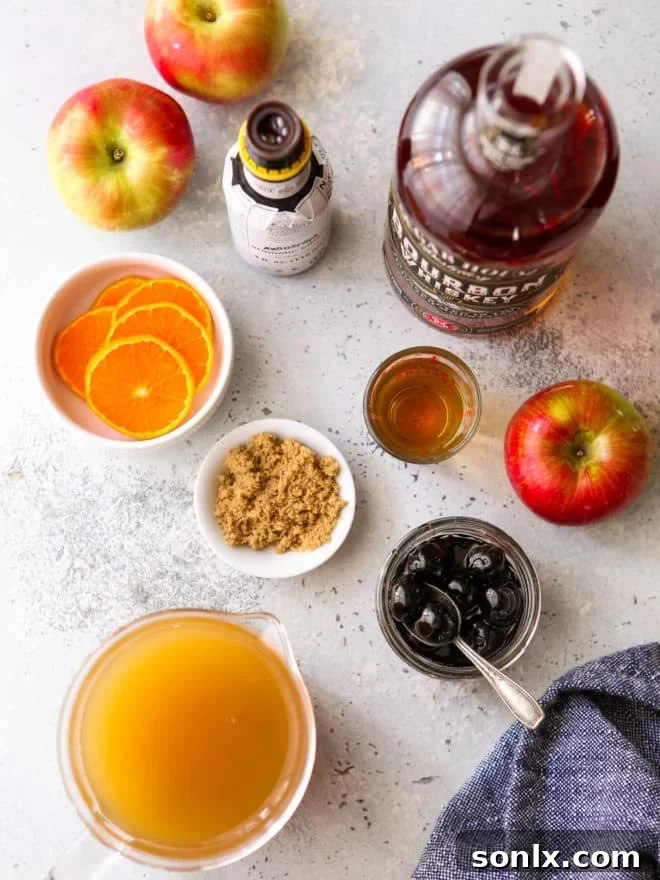 ingredients for apple cider old fashioned cocktail laid out