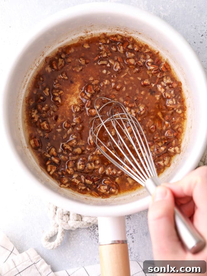 Maple pecan sauce being prepared for topping roasted sweet potatoes, a rich and aromatic glaze.