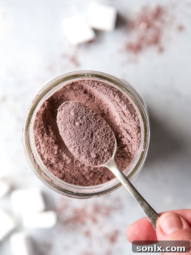 Homemade hot cocoa mix stored in a glass jar, ready for gifting.