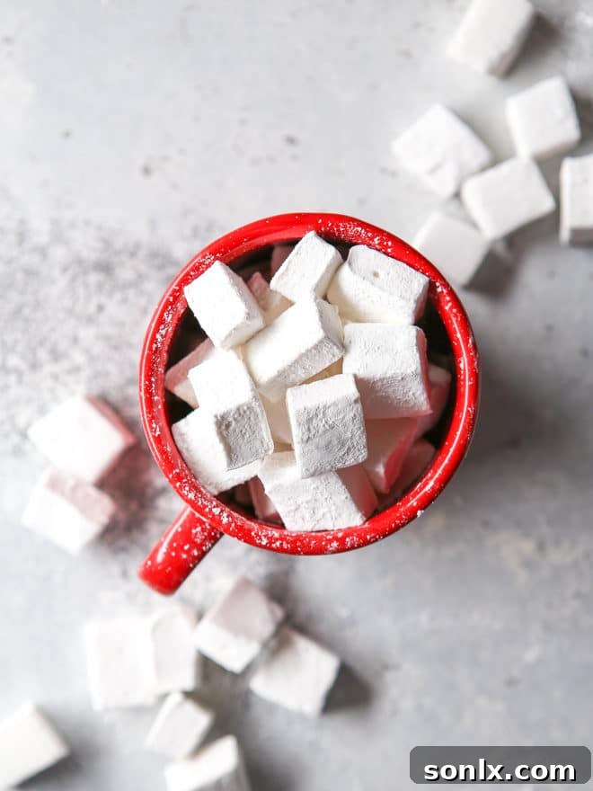 Homemade marshmallows, soft and fluffy, piled high as a topping for hot cocoa.