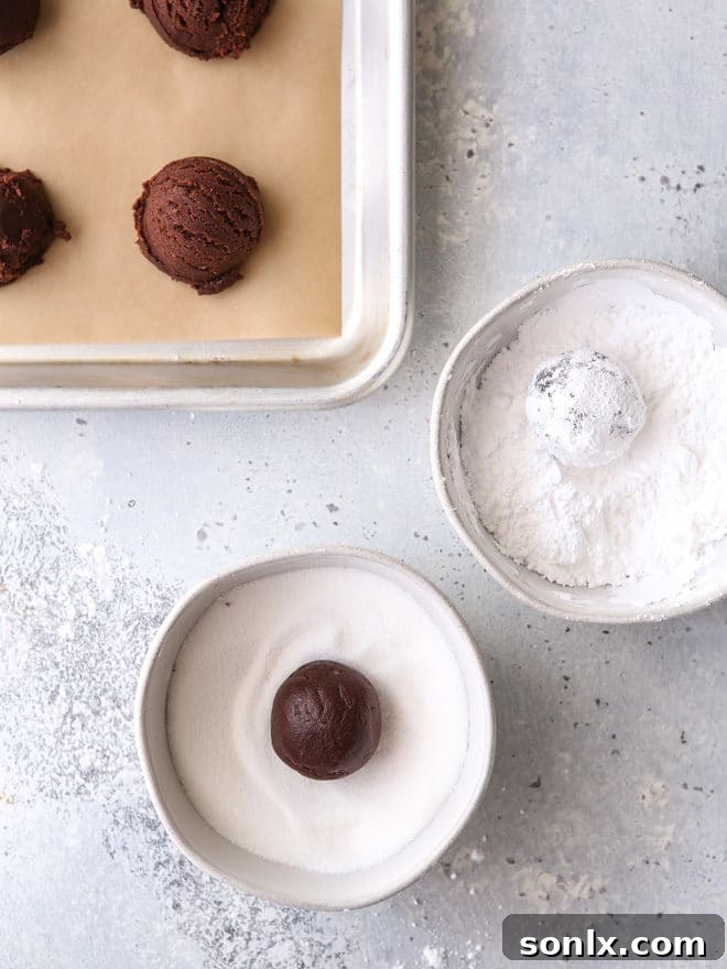 Roll cookies in granulated sugar and powdered sugar to prevent powdered sugar from absorbing into cookie, creating a distinct crinkle.