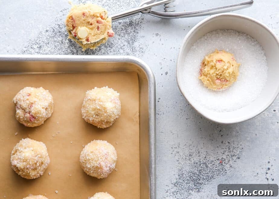 scooping peppermint white chocolate cookie dough onto a baking sheet