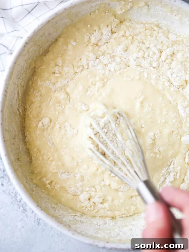 A stack of perfectly cooked buttermilk waffles, golden and inviting, ready for toppings.