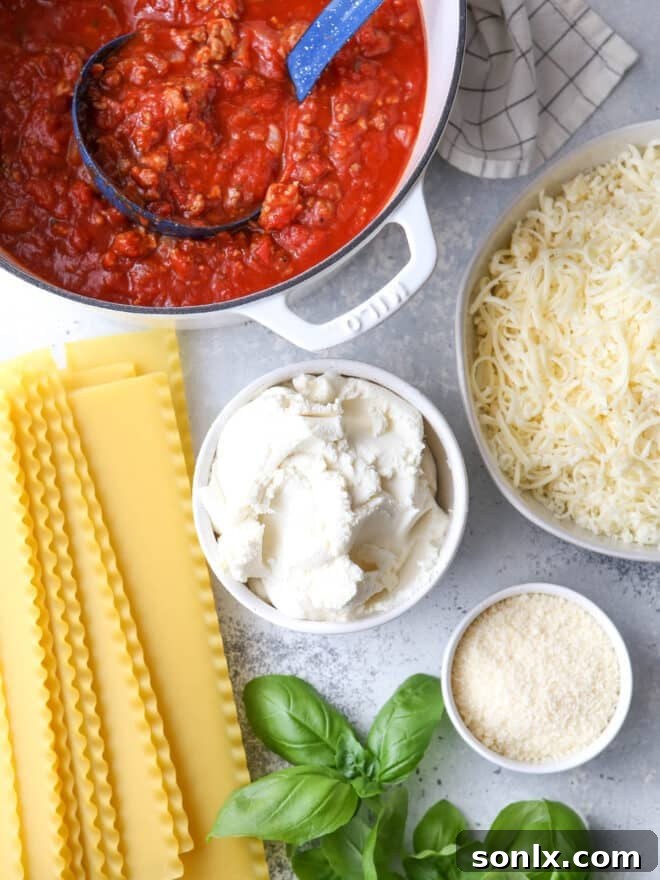 Ingredients for making a classic homemade lasagna, laid out on a kitchen counter.