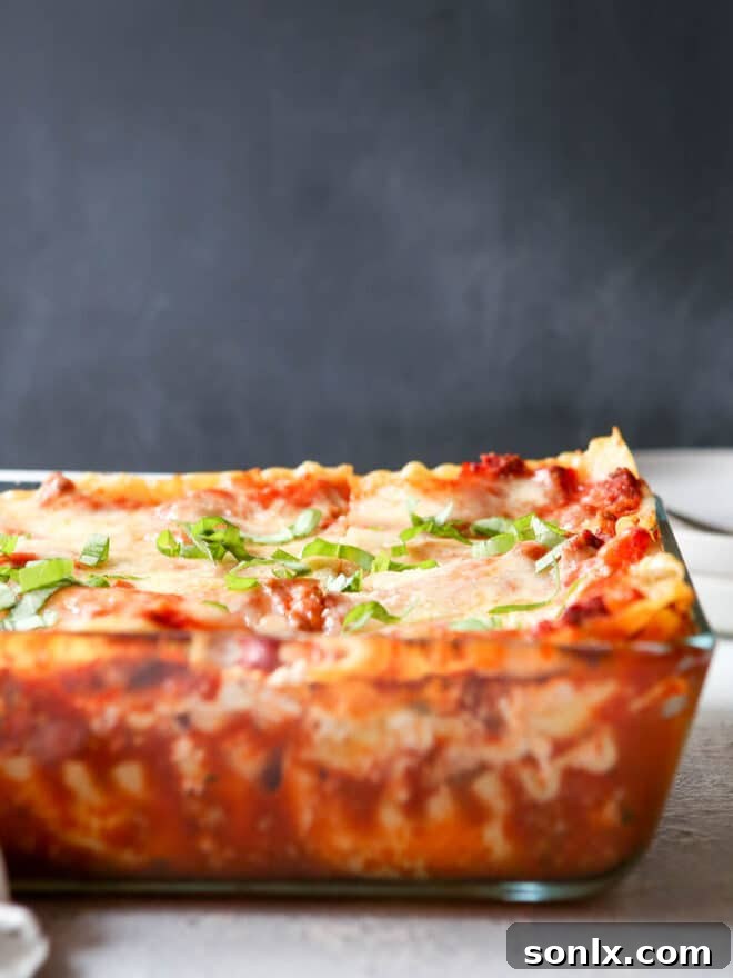 Freshly baked lasagna in a casserole dish, golden brown and bubbling.