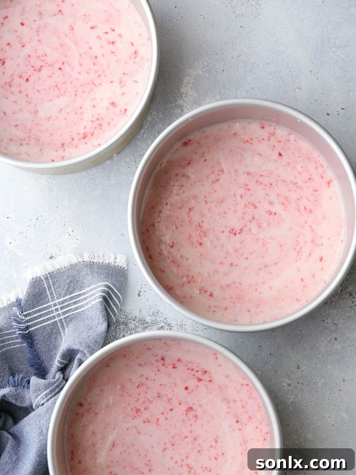 Creaming butter and sugar, then adding egg whites for cherry chip cake batter