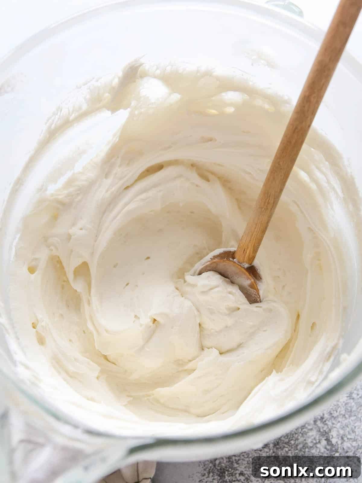 Bowl of freshly whipped vanilla buttercream frosting, ready for a cherry chip cake