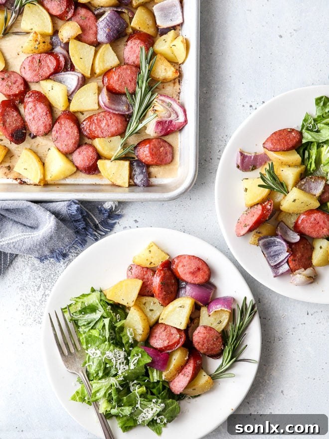 A vibrant sheet pan filled with golden-brown sausage, roasted potatoes, and caramelized onions, ready to serve.