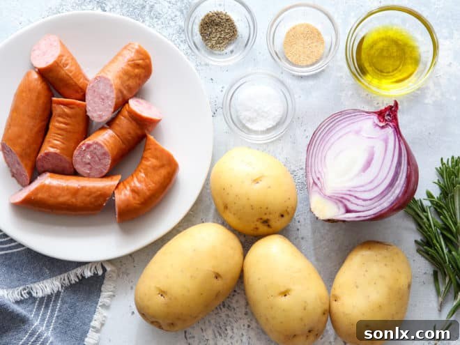 Various chopped ingredients including sausage, potatoes, and red onion in a mixing bowl, ready to be seasoned.