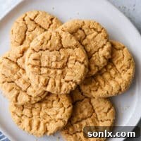 Flourless peanut butter cookies stacked on a plate, ready to be served.