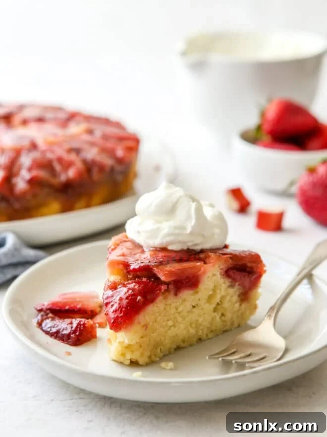 A beautifully caramelized Strawberry Rhubarb Upside-Down Cake, showcasing the vibrant fruit topping.