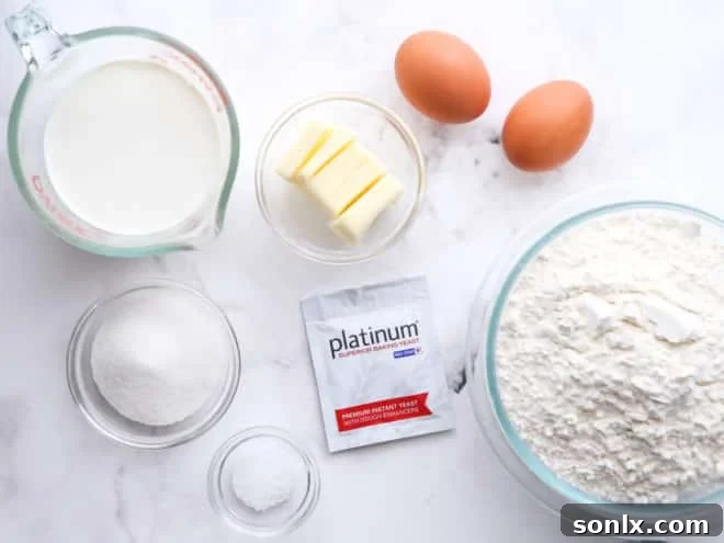 a collection of fresh ingredients laid out, including flour, sugar, milk, butter, eggs, and yeast, ready for making doughnuts
