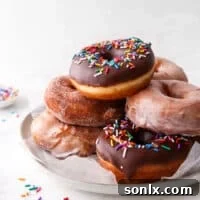 yeast-raised doughnuts stacked on a plate