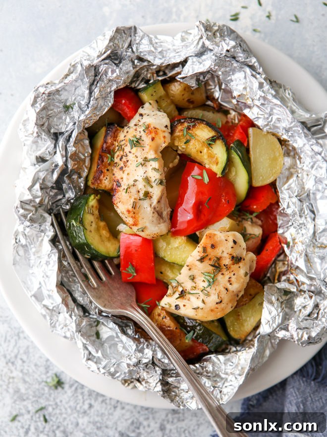 Delicious chicken and veggie tin foil dinners, a complete and hearty meal cooked over a fire, on the grill, or in the oven, ready to be enjoyed.