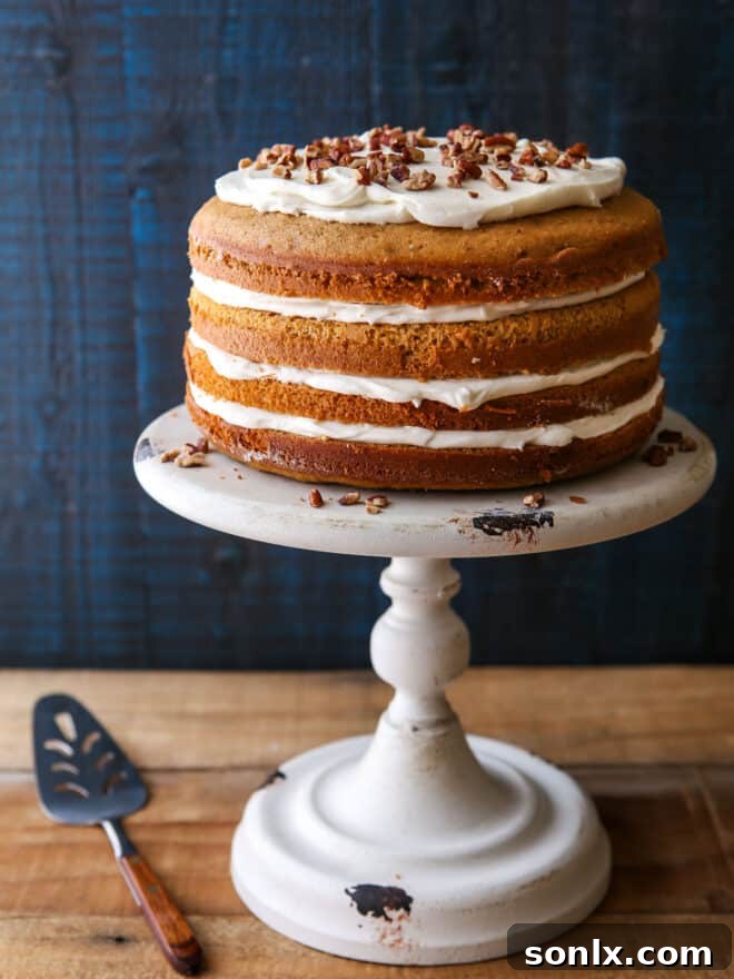 A beautifully decorated Sweet Potato Spice Cake with Vanilla Bean Cream Cheese Frosting, ready to be served.