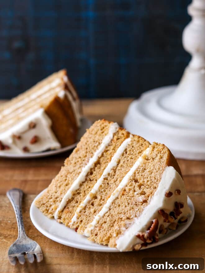 Close-up of a slice of Sweet Potato Spice Cake, showing its moist layers and creamy frosting.