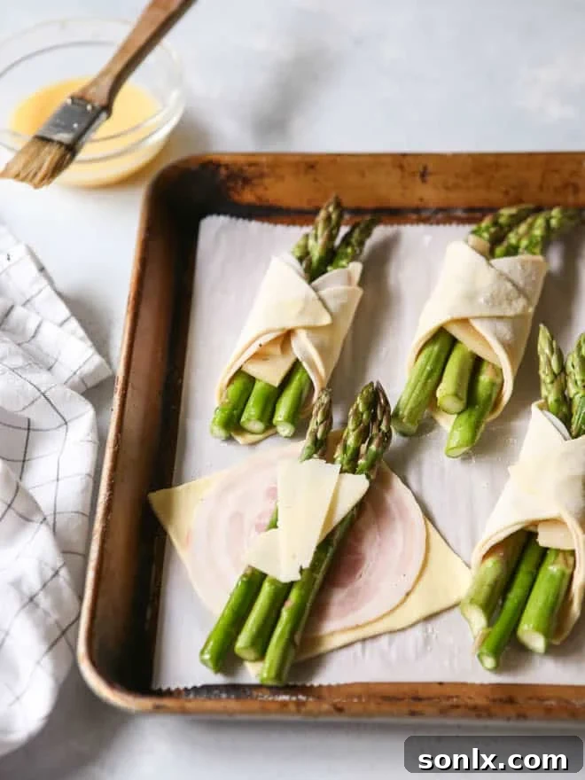 Golden brown puff pastry bundles filled with green asparagus and savory pancetta.