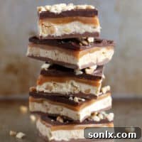 Delicious Homemade Snickers Bars, a multi-layered candy bar recipe perfect for celebrations.