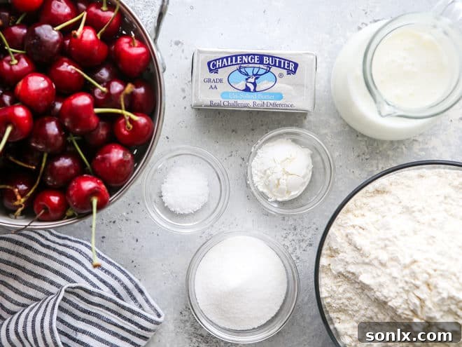 Ingredients for making homemade cherry hand pies, including butter, flour, and fresh cherries