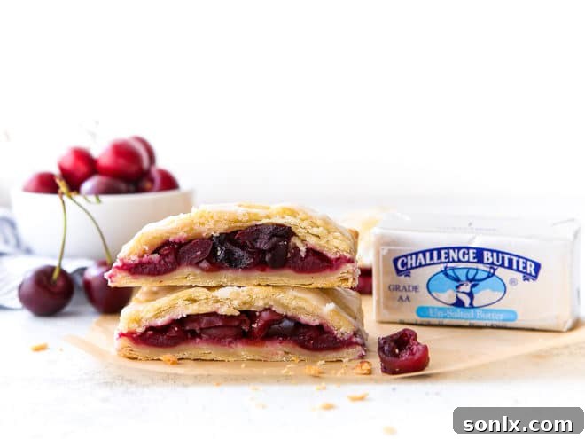 cherry hand pies cut in half and stacked with a block of Challenge Butter beside them
