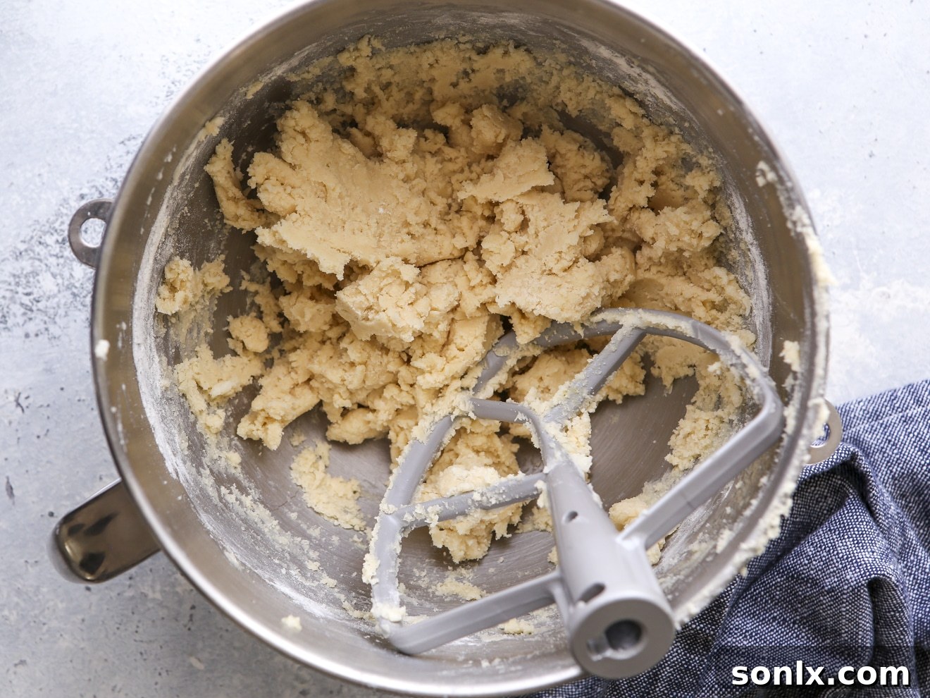 Creamy sugar cookie dough in a stand mixer bowl, perfectly mixed and ready for the next step of preparation.