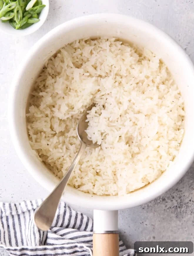 Perfectly steamed white rice in a saucepan