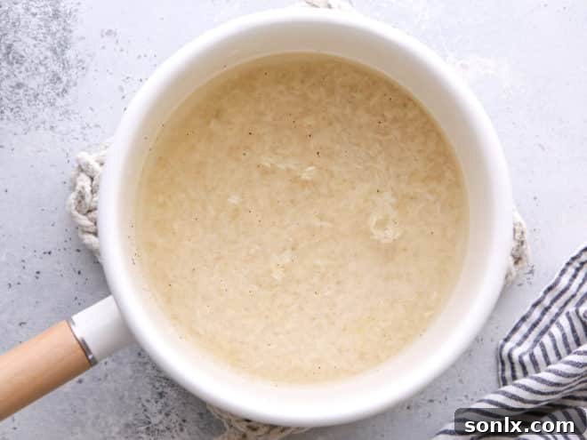 Adding water to a pot of rice on the stovetop