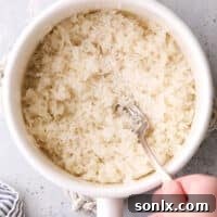 Fluffing steamed rice in a pot