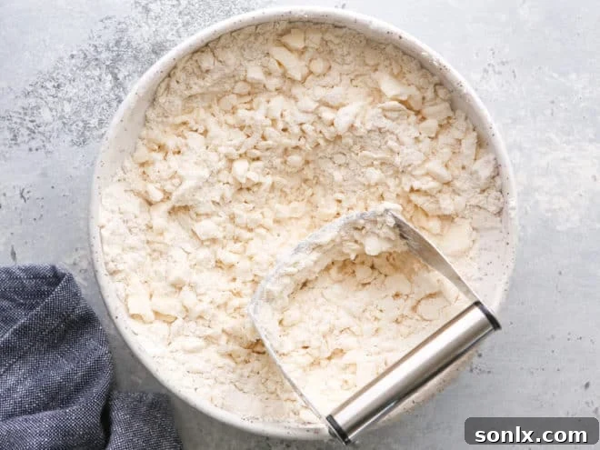 cutting butter into flour for puff pastry