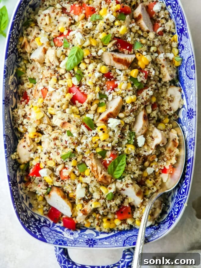 Close-up shot of grilled chicken quinoa salad showing texture and ingredients in a blue dish