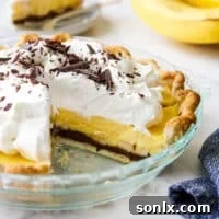 A tempting image of a chocolate bottom banana cream pie with slices taken out, clearly showing all the decadent layers.