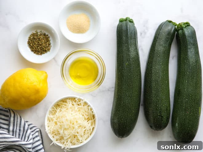ingredients for grilled parmesan zucchini, including zucchini, lemon, olive oil, and seasonings
