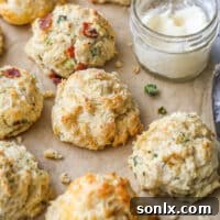 buttermilk drop biscuits with different mixins on a sheet of parchment closeup