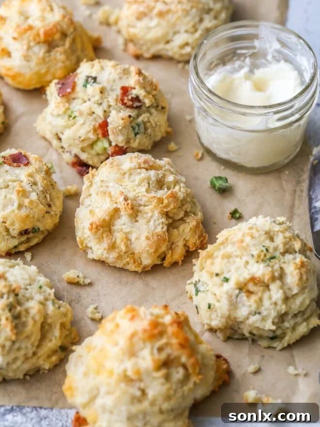 buttermilk drop biscuits with different mixins on a sheet of parchment closeup