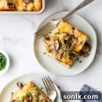 Slices of Sausage and Mushroom Breakfast Casserole on plates, ready to be enjoyed.