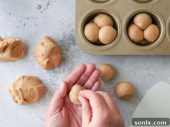 Forming whole wheat cloverleaf rolls by dividing dough into small balls