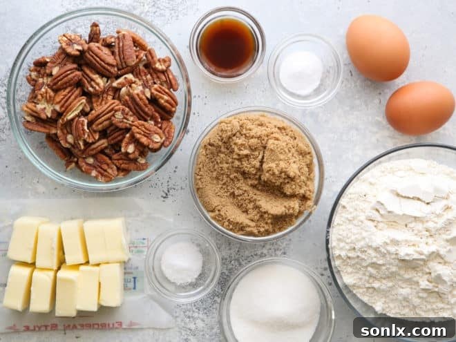 A selection of fresh ingredients for brown butter pecan cookies laid out, including butter, sugars, eggs, flour, and whole pecans.