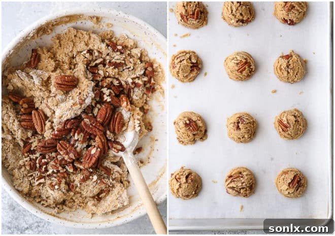 A large mixing bowl filled with thick, rich brown butter pecan cookie dough, ready for scooping and baking.