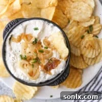 Rich Caramelized Onion Dip 8 Homemade French onion dip in a serving bowl with potato chips.