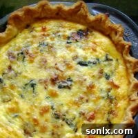 A perfectly baked Quiche with Bacon and Spinach, golden brown and ready to serve.