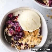 A simply perfect blueberry almond crisp, with a juicy berry filling and crunchy almond-oat topping, ready to be served.