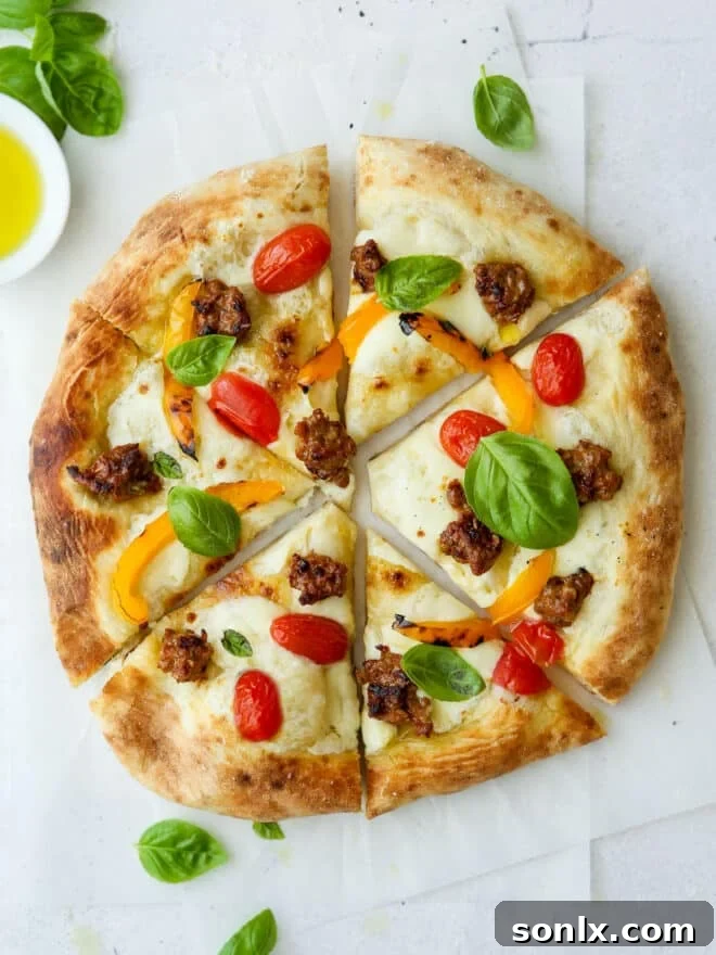 Close-up of a freshly baked Italian sausage pizza slice with vibrant toppings