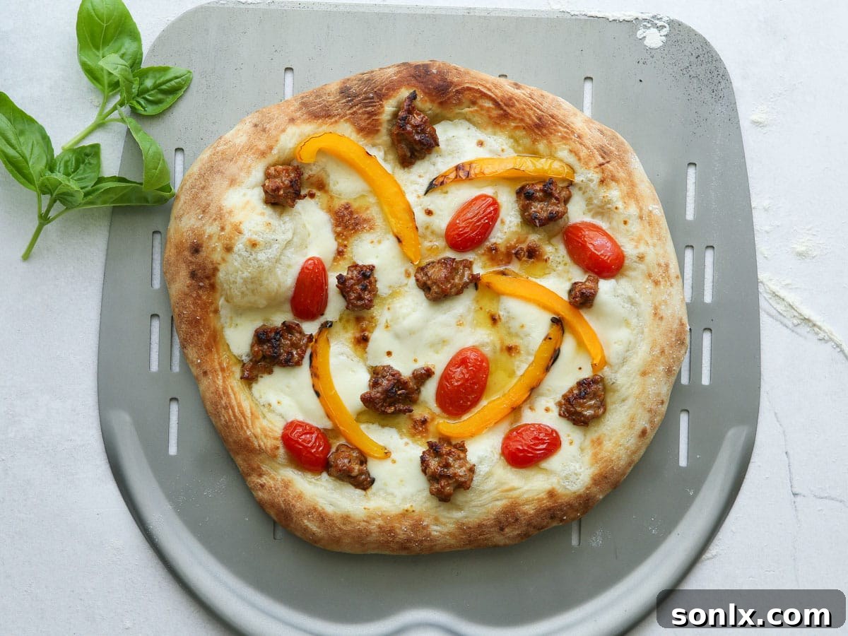 Freshly baked Italian sausage pizza on a pizza peel, ready to be served