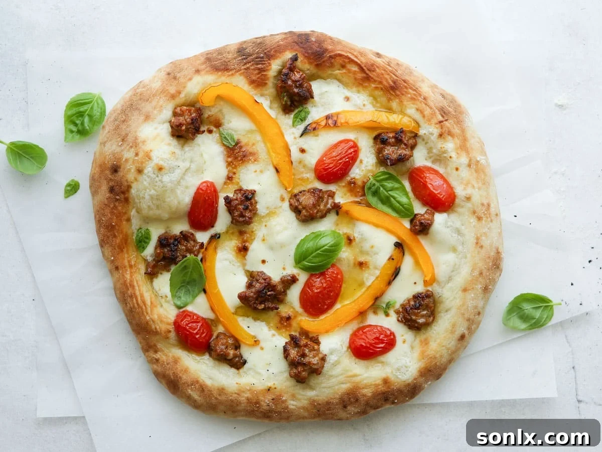 Italian sausage pizza with fresh basil before slicing