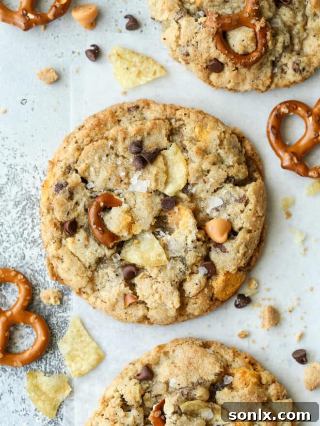 Closeup of perfectly baked kitchen sink cookies with visible pretzels, chocolate chips, and potato chip pieces