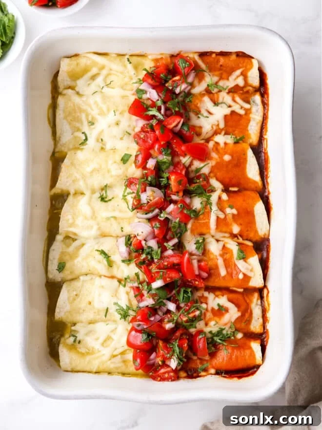Red and Green Chicken Enchiladas on a baking dish, half with red sauce and half with green sauce, ready to be served.