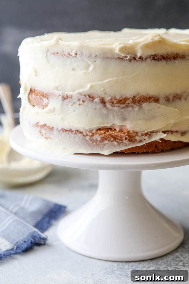 A luscious image of the creamiest cream cheese frosting, showcasing its smooth texture and inviting peak, ready to adorn any sweet treat.