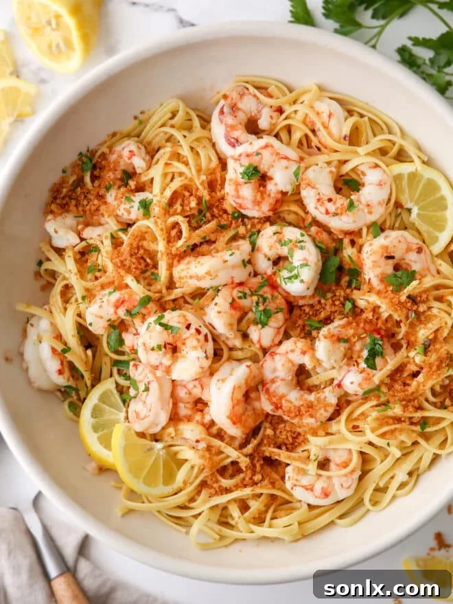 closeup of shrimp scampi pasta in a big bowl, garnished with fresh parsley
